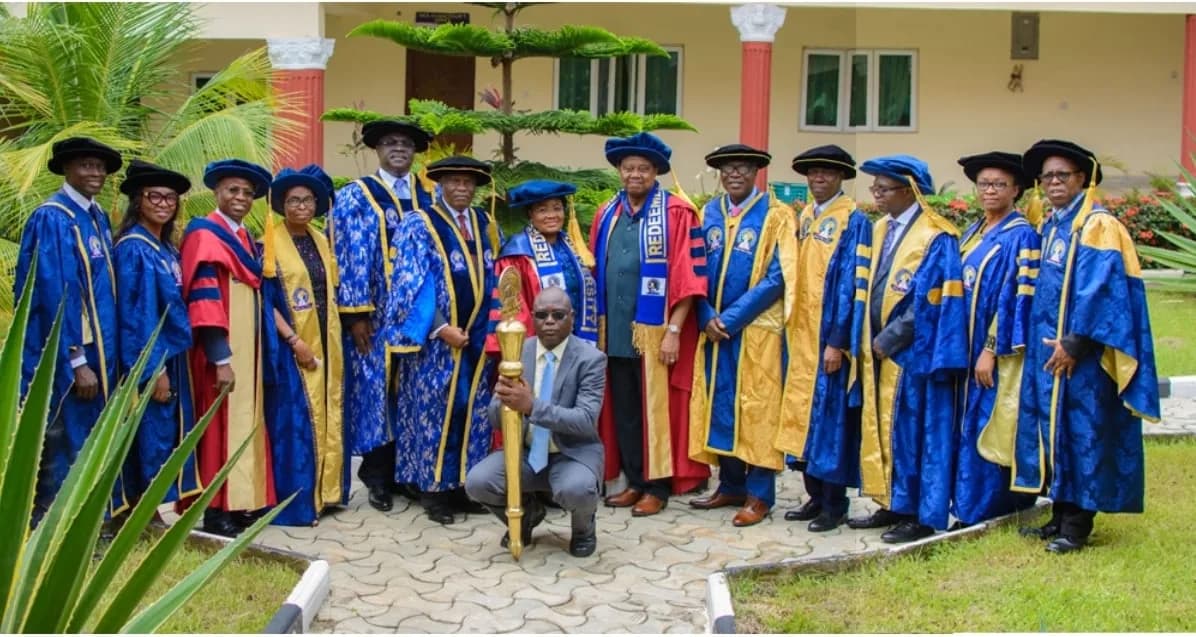 Academic staff in colourful convocation robes posing in a group