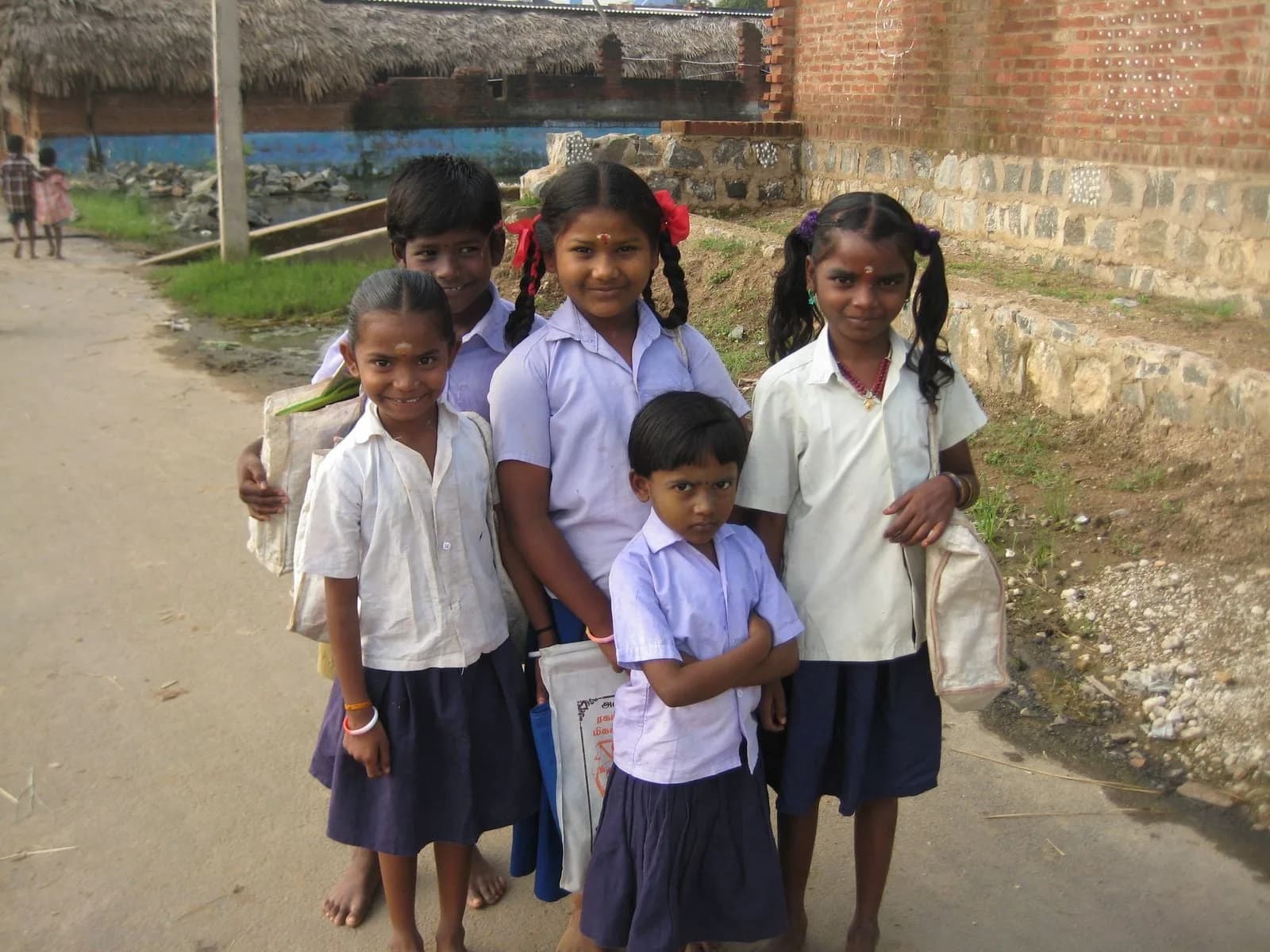 A group of Indian schoolchildren in uniform standing outdoors