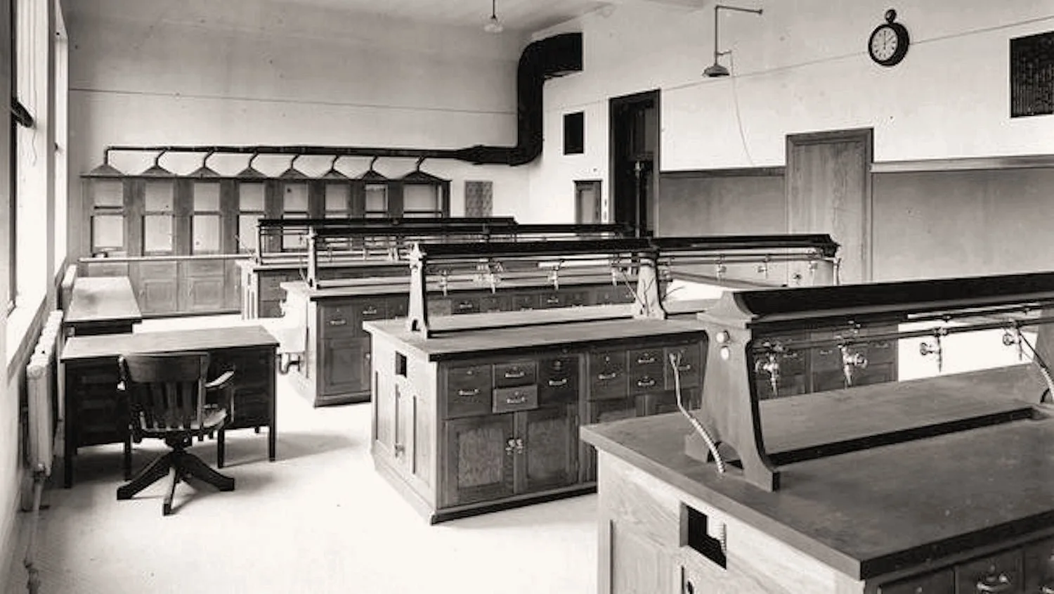 A school chemistry laboratory with benches and equipment in an old photograph