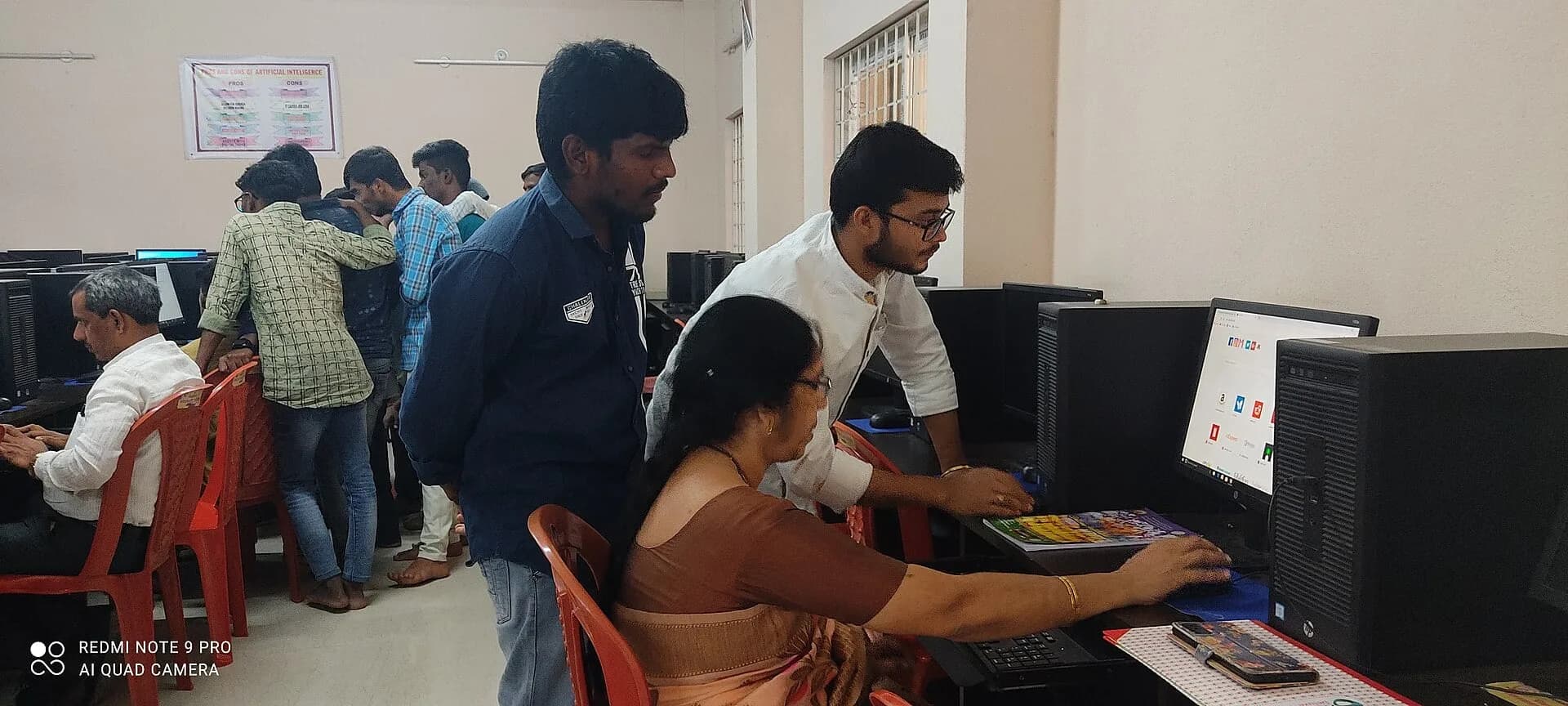 Students in a college computer lab in Andhra Pradesh with a teacher