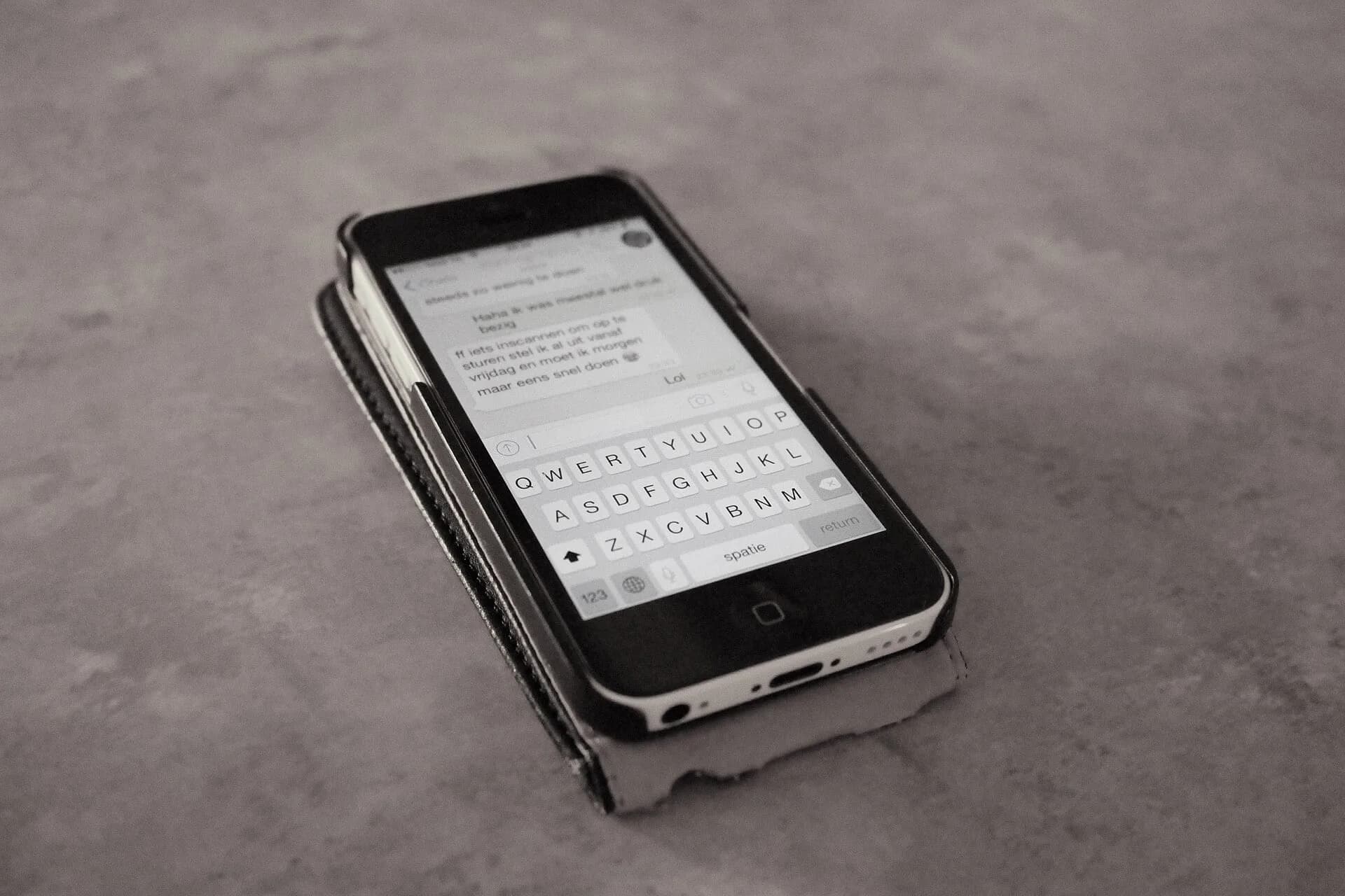 A smartphone showing a text message on a table