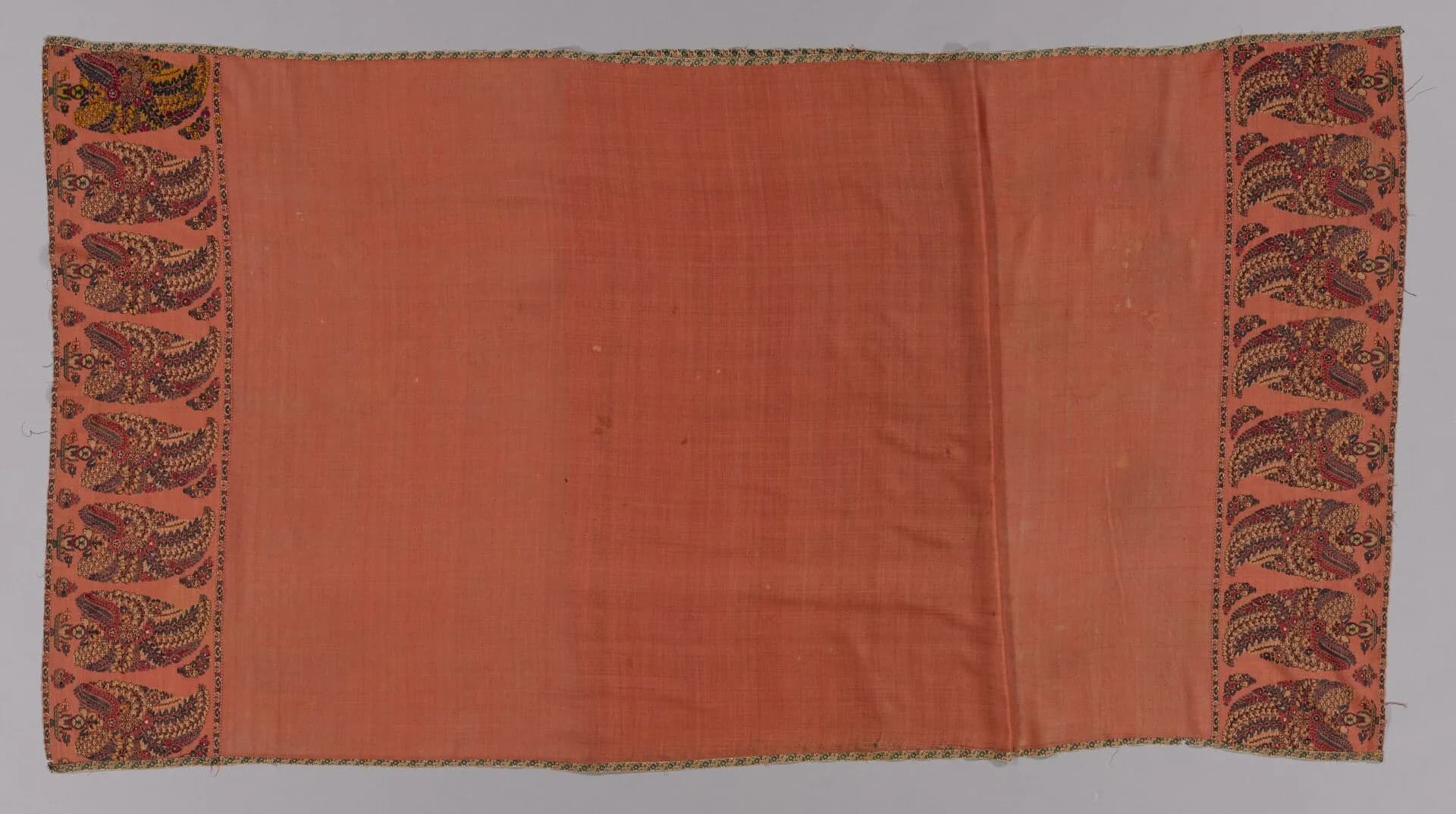 An 18th-century Kashmiri long shawl with an apricot field and patterned buta borders at both ends