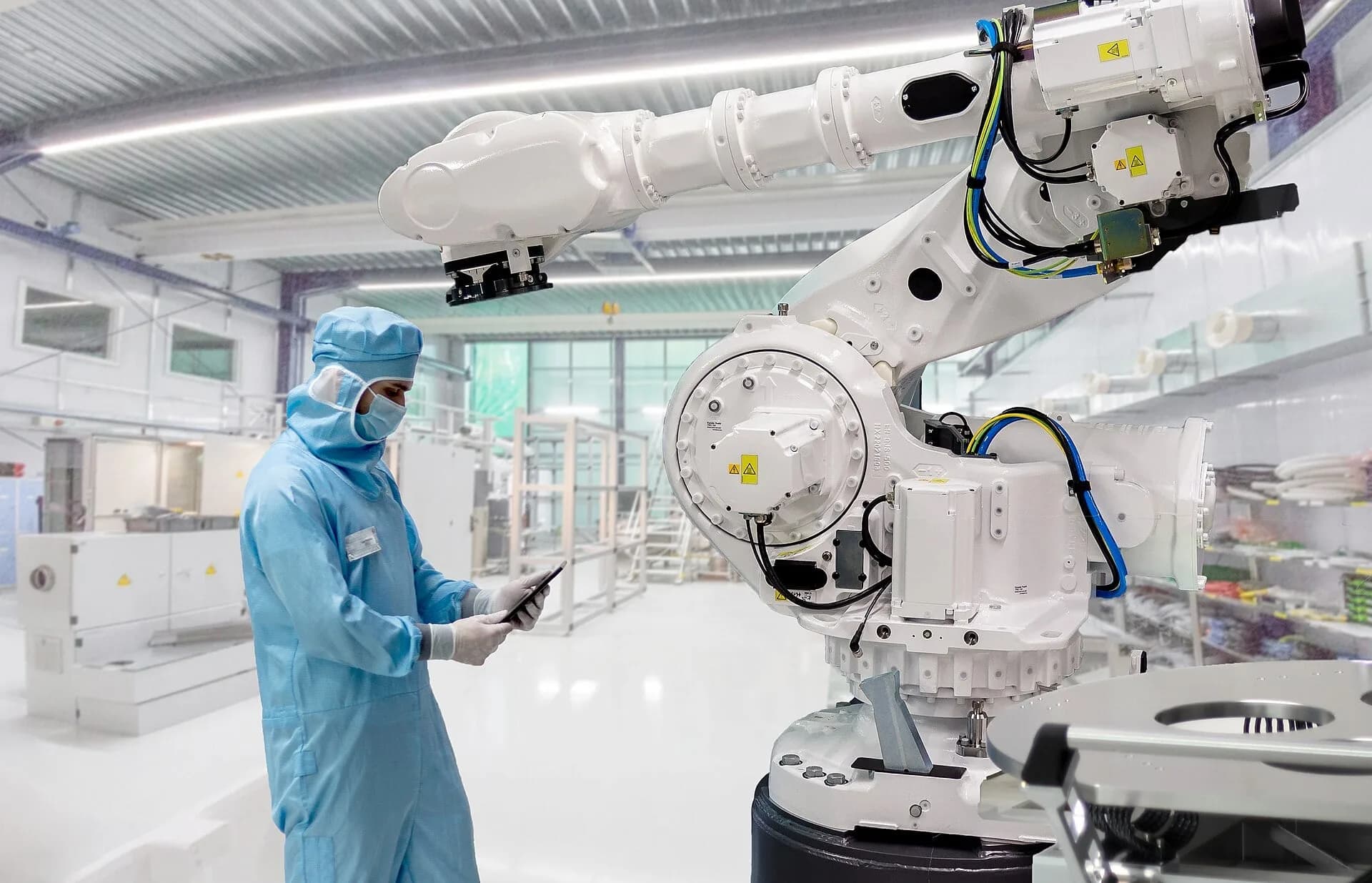 Workers in protective suits in a factory cleanroom