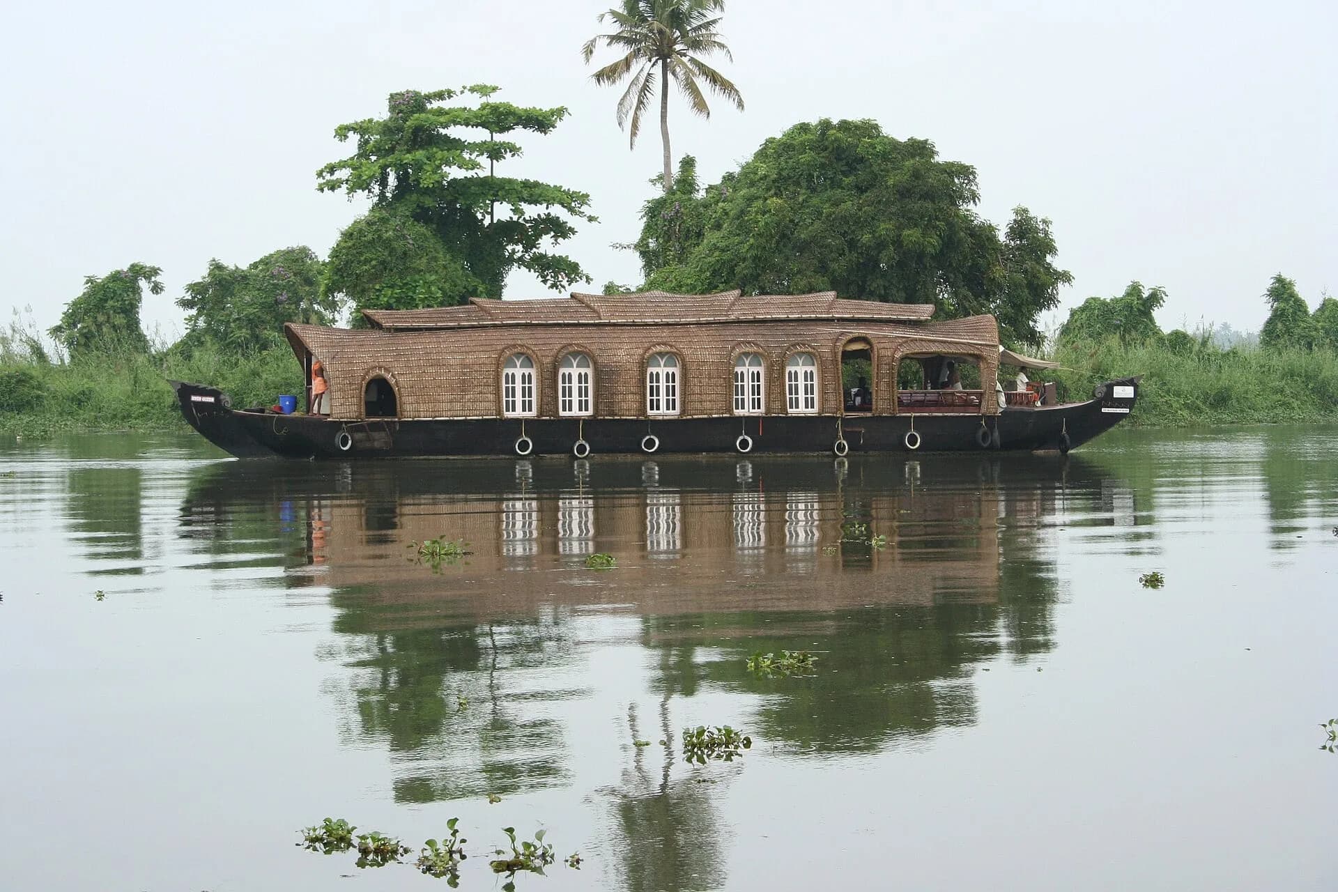 A Kerala houseboat reflected in still water