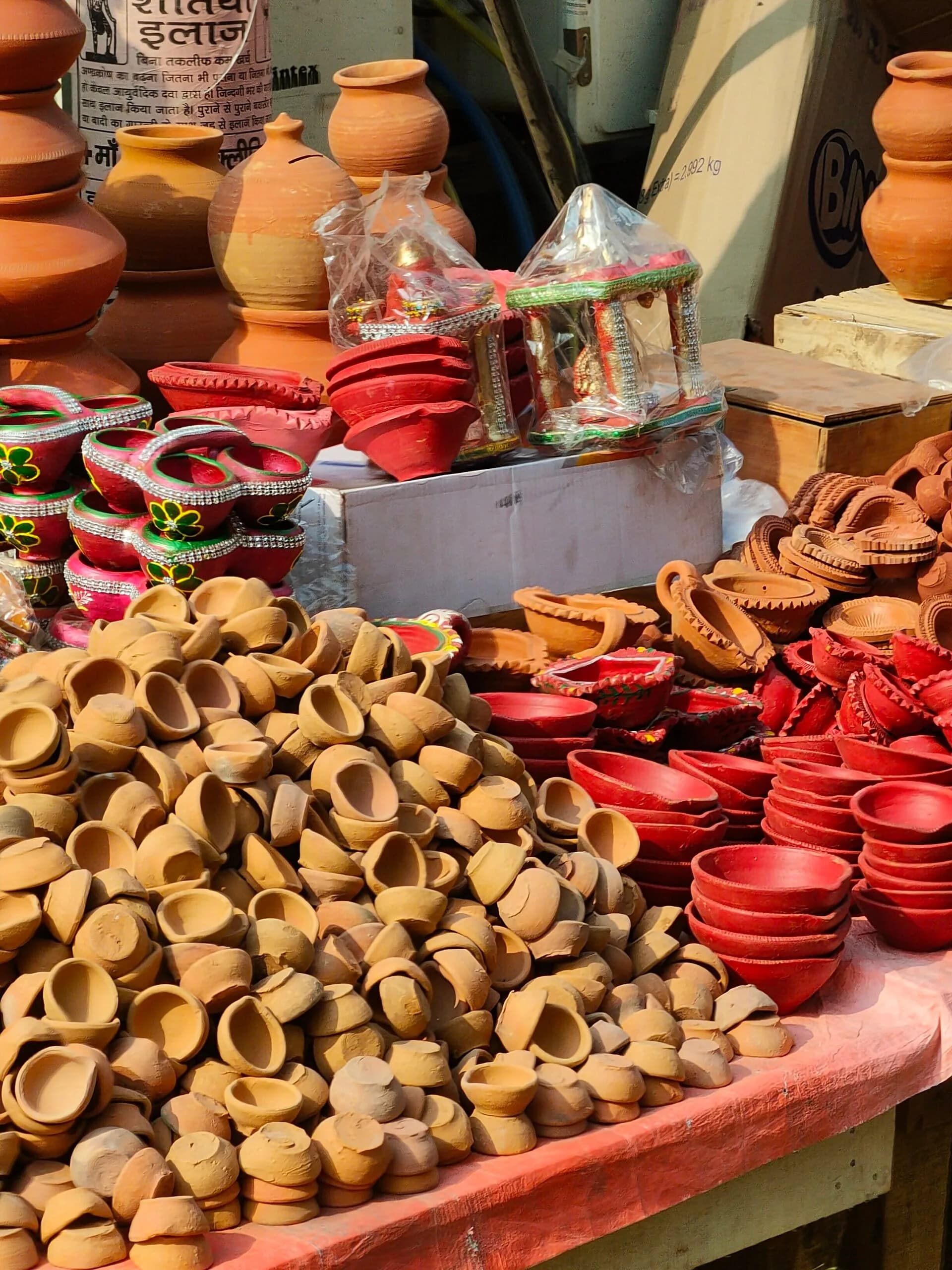 Clay diyas laid out for sale on a street