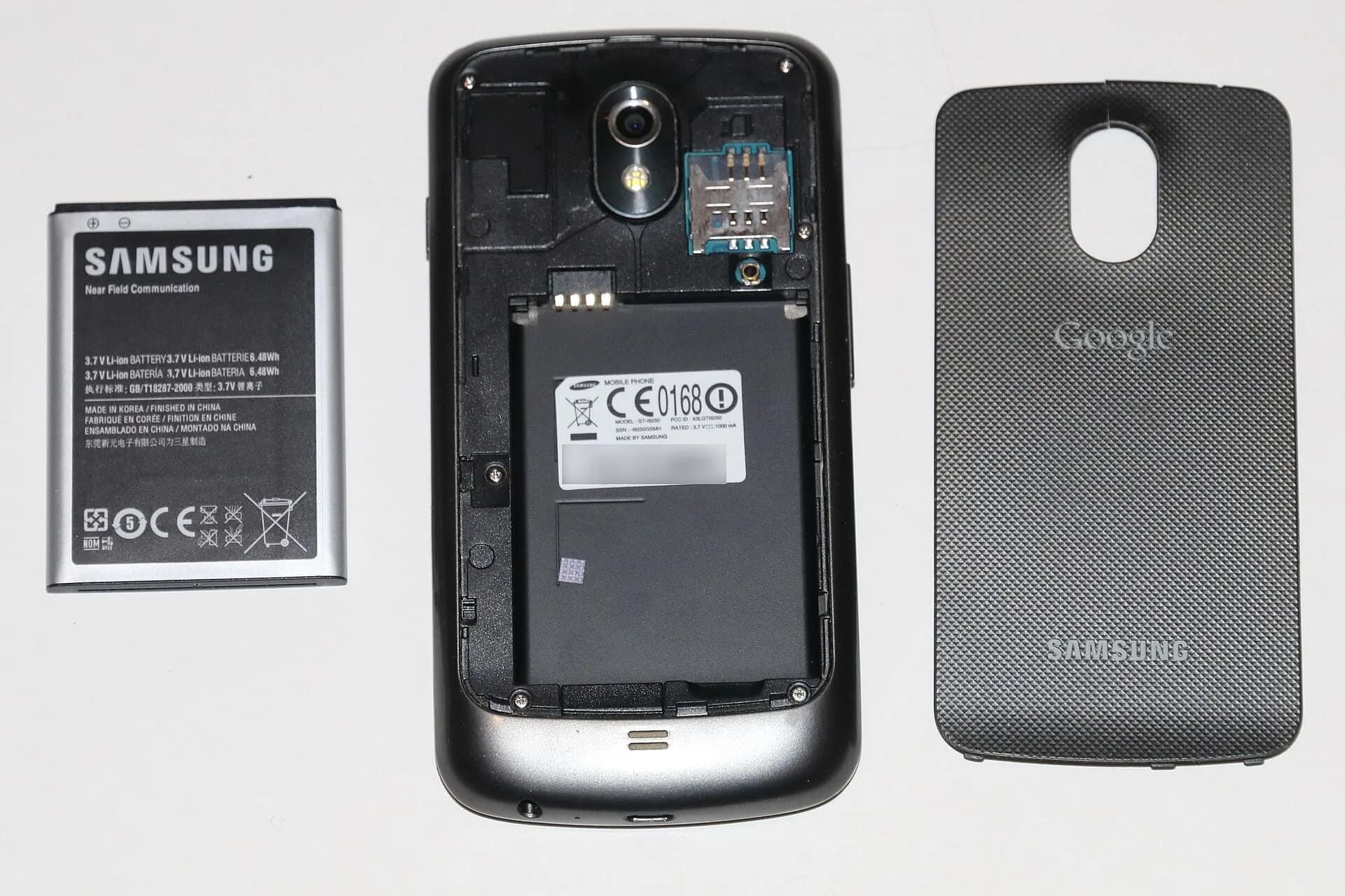 A smartphone with its back cover removed, showing the battery