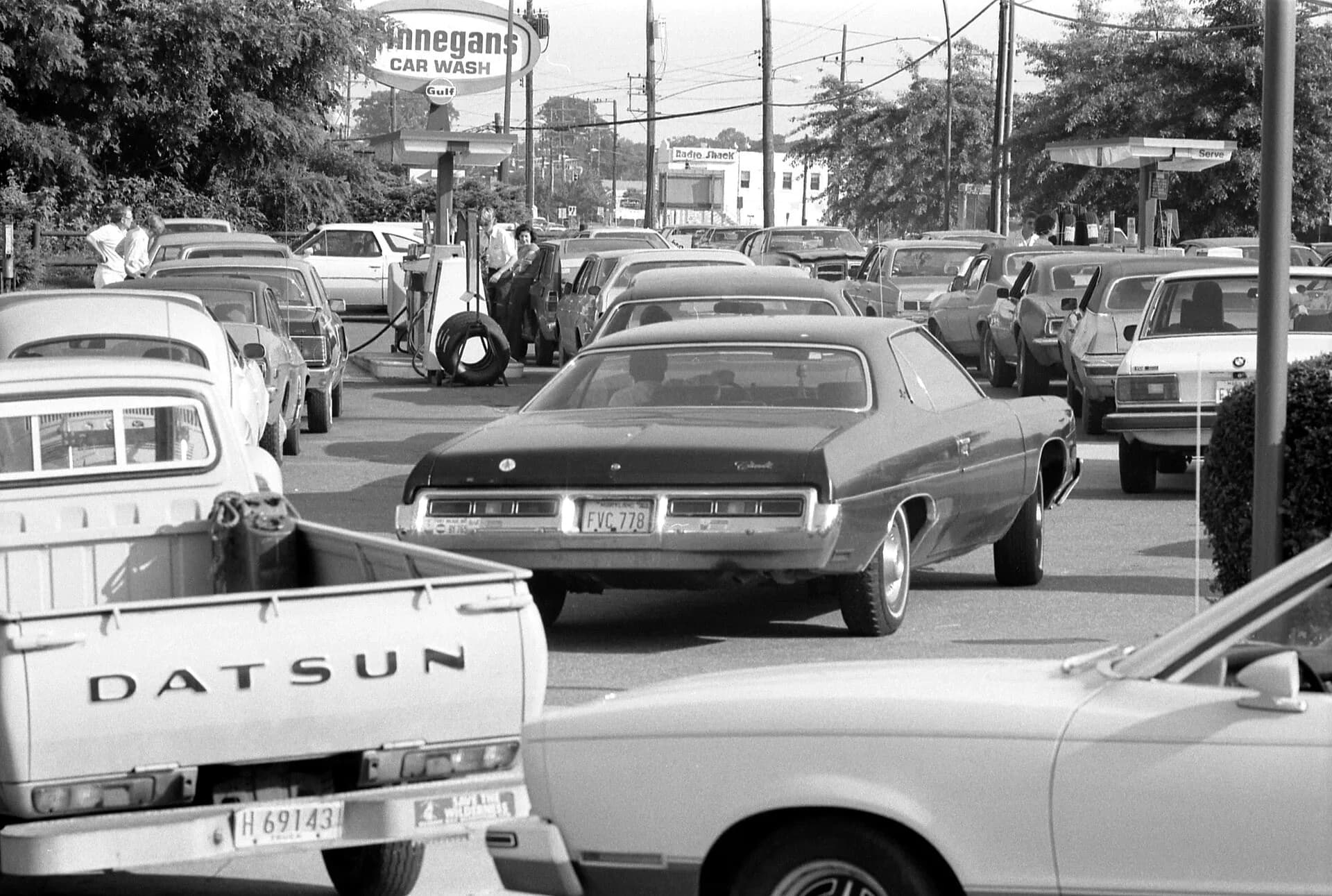 Cars queuing at a petrol station in the 1970s