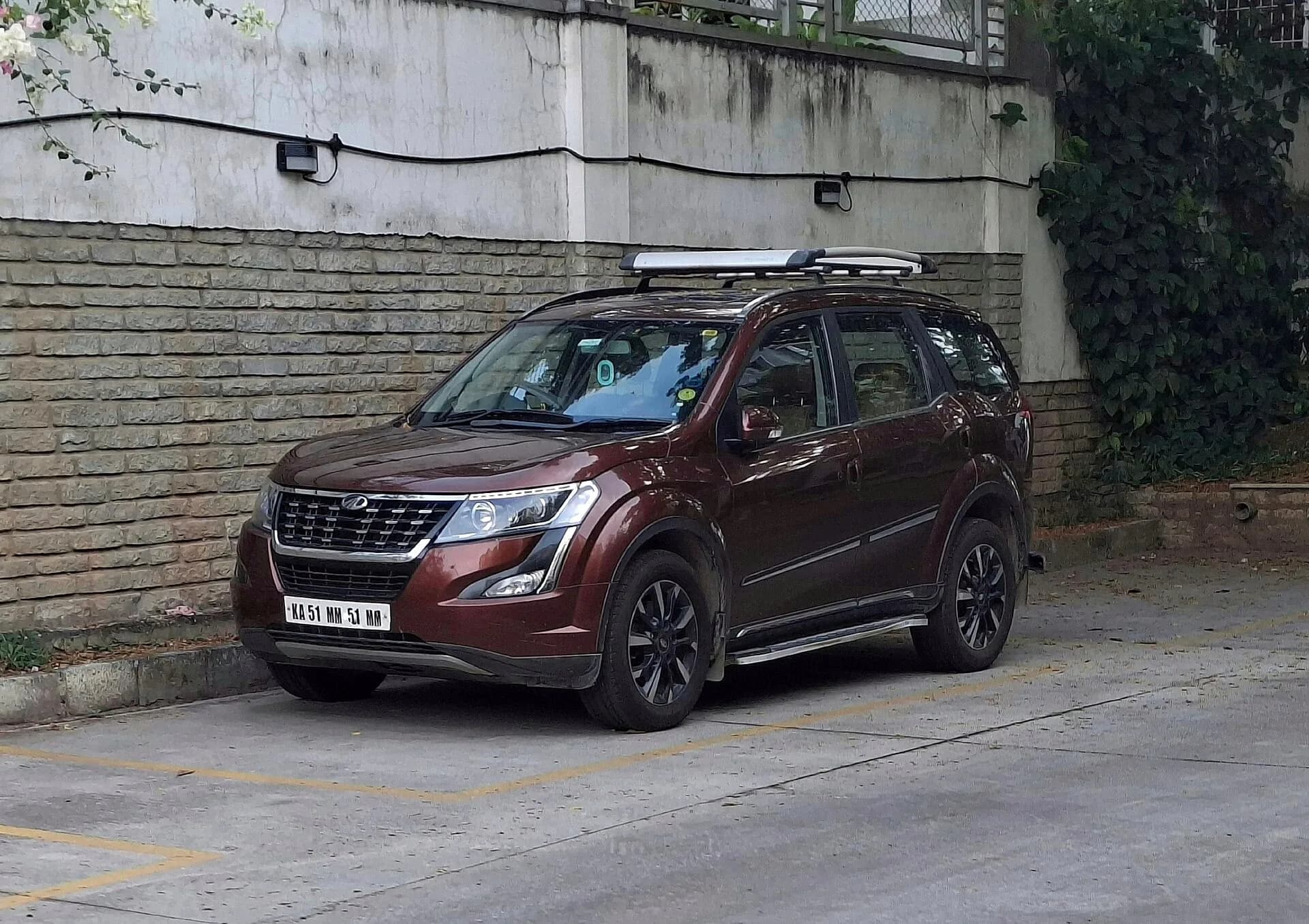 A Mahindra XUV500 SUV parked by a wall