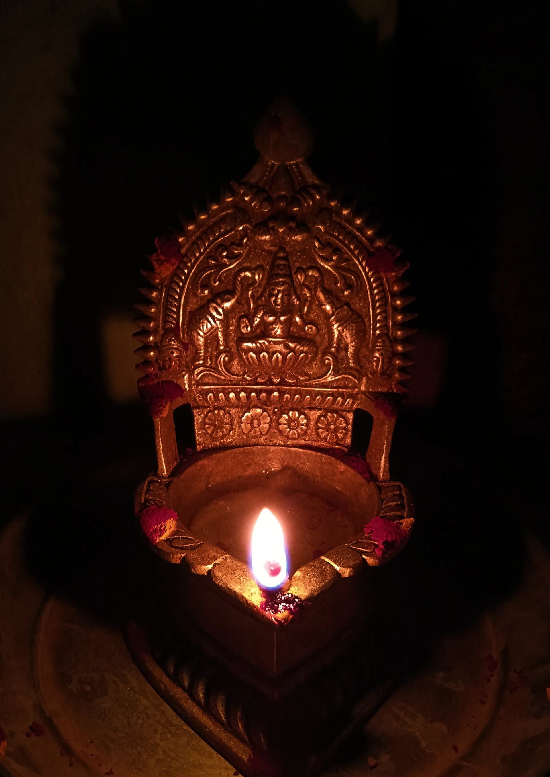 A tall brass Kamatchi lamp of the kind used in South Indian homes