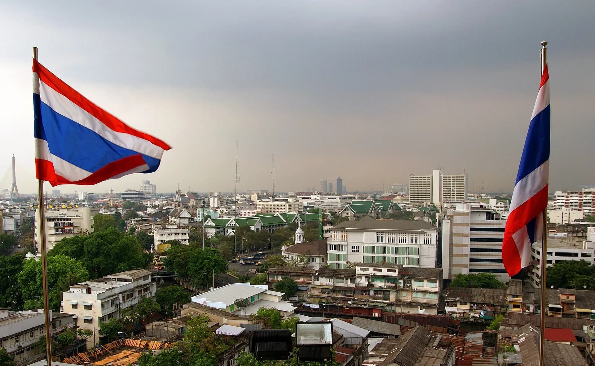 The Bangkok skyline with Thai flags in the foreground