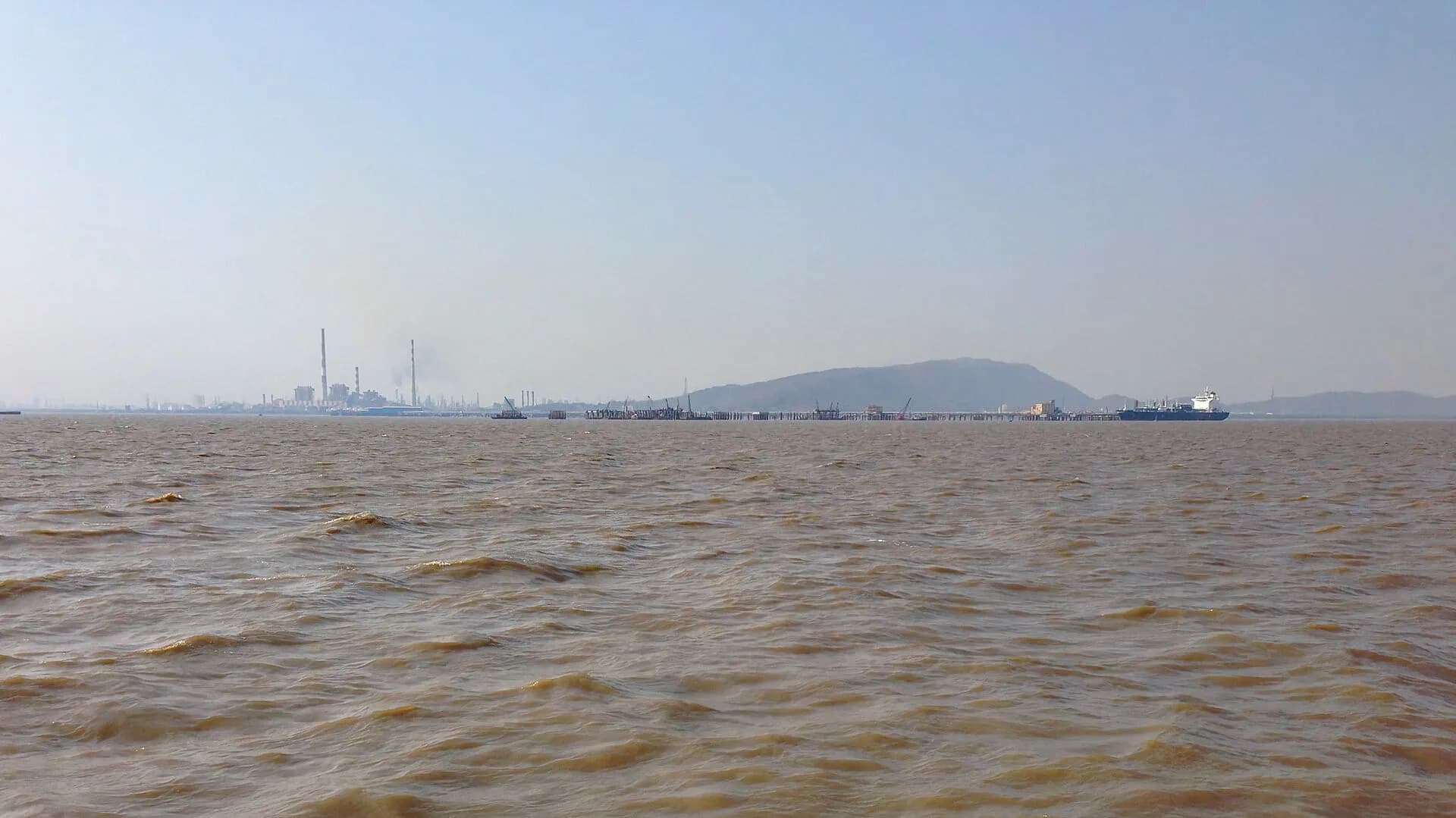 An oil refinery seen across the sea off Mumbai