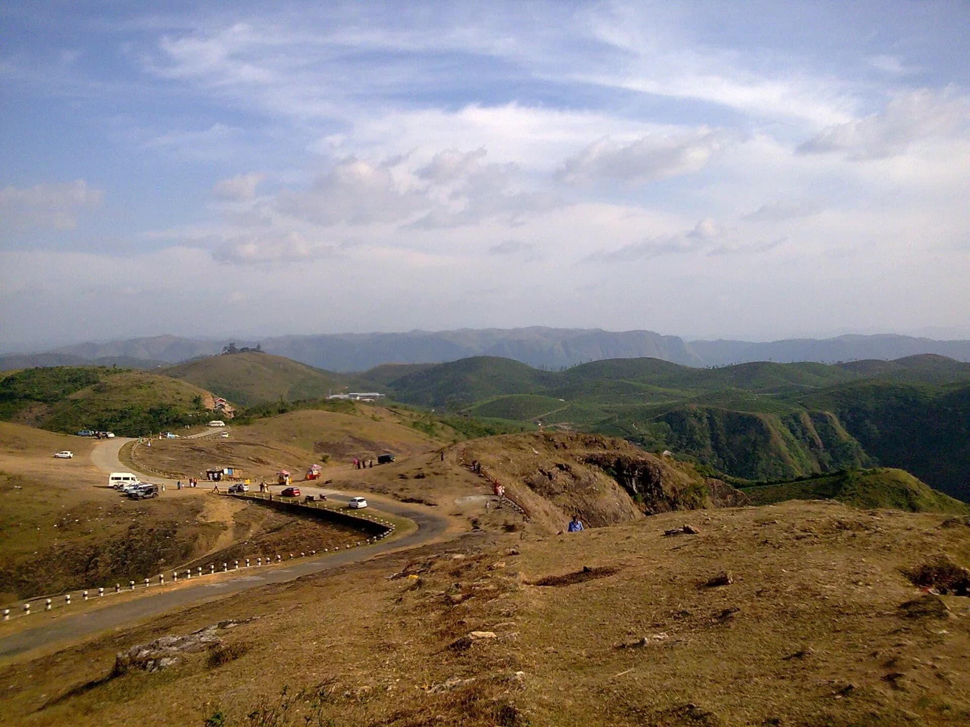 Rolling green hills and a winding road at Parunthumpara in Idukki district, Kerala