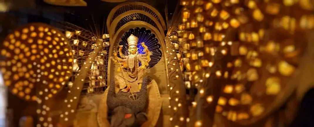A brightly lit Durga Puja pandal with the goddess idol