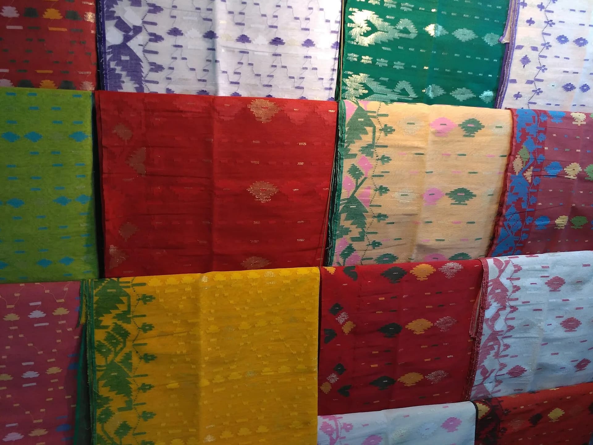 Stacks of colourful Jamdani sarees
