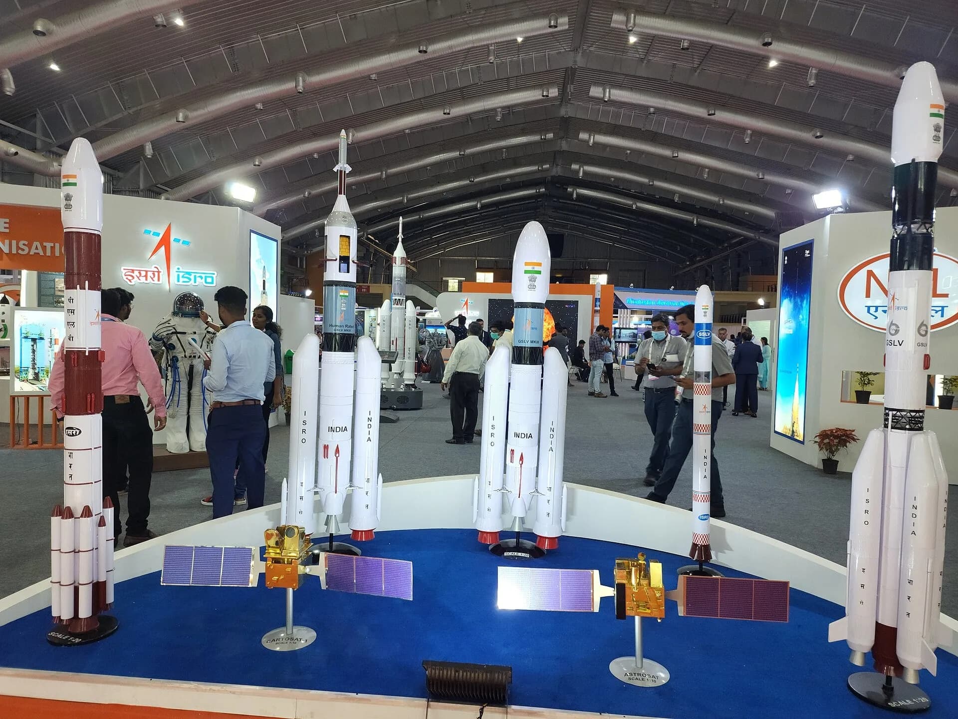 Scale models of ISRO launch vehicles and satellites at an exhibition
