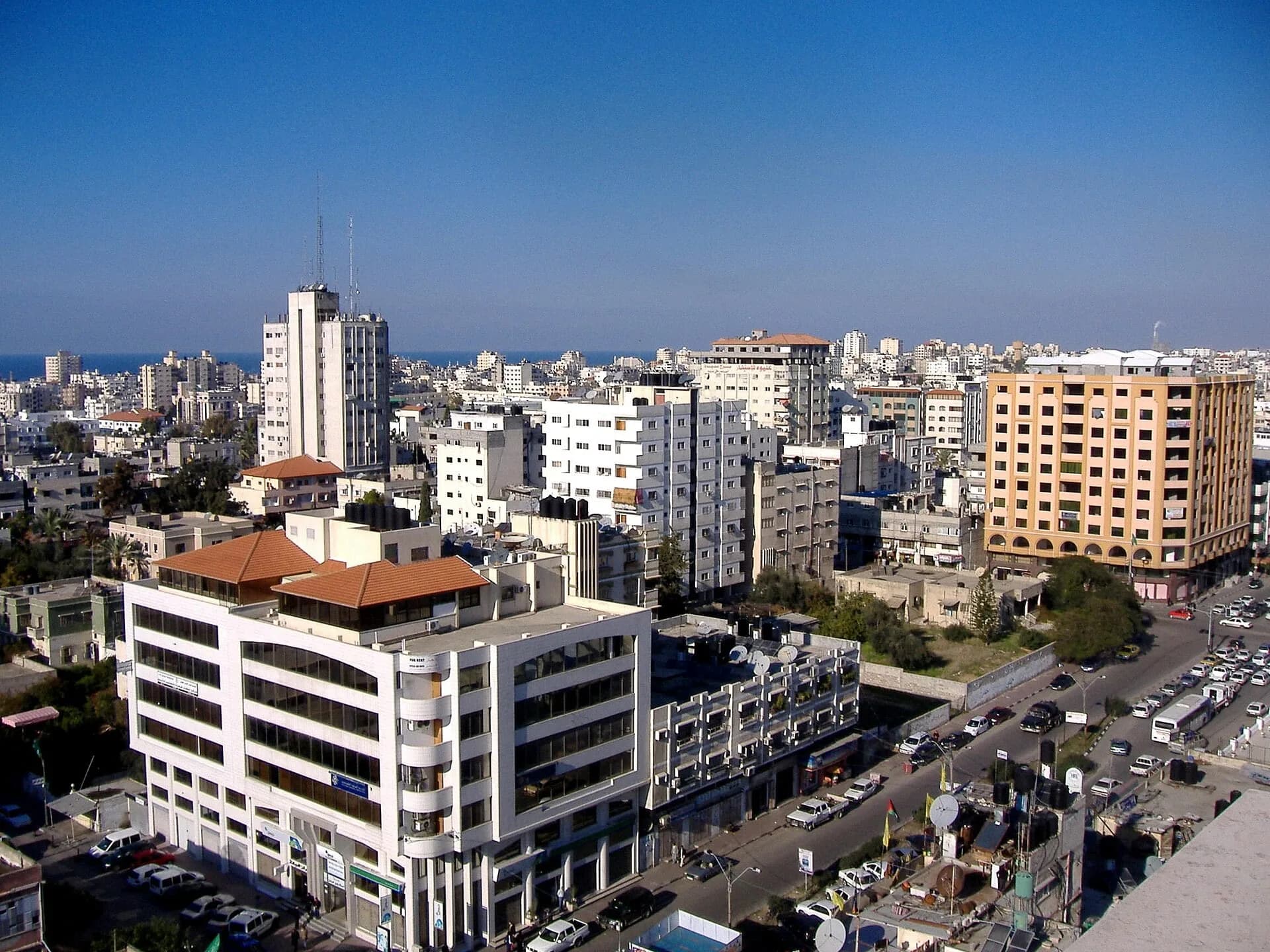 Apartment buildings in Gaza City under a clear sky, photographed before the war
