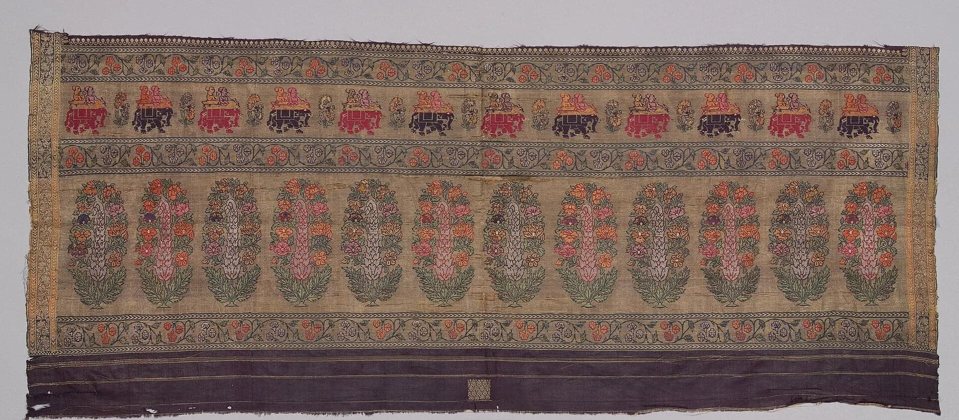 A woven sari border with gold and coloured motifs