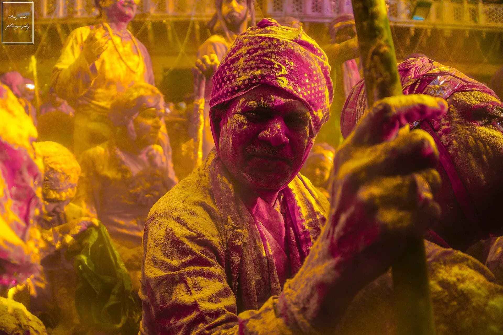 People covered in bright colours during Holi celebrations in Mathura