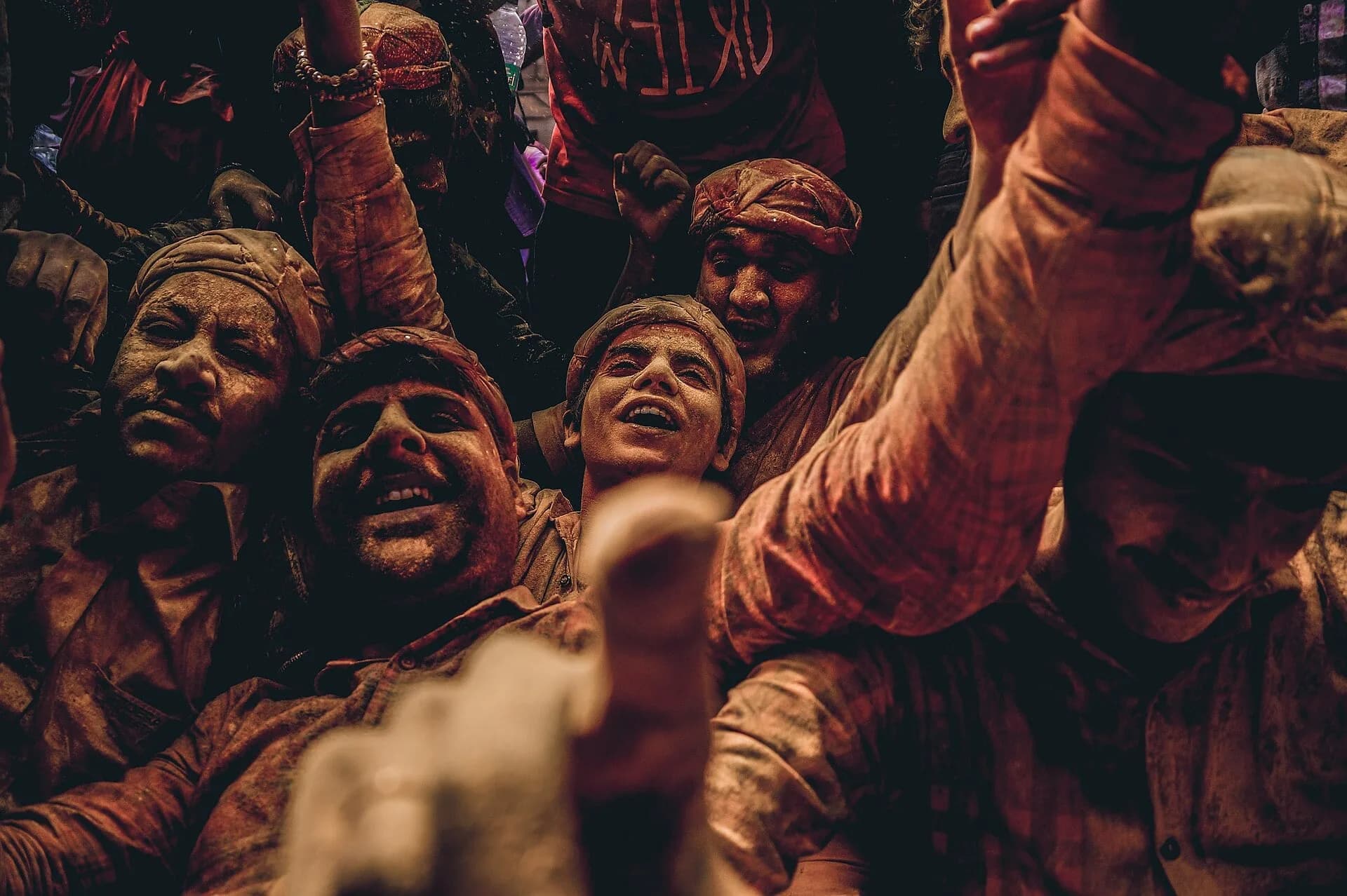 A crowd playing with coloured powder during Holi in Mathura