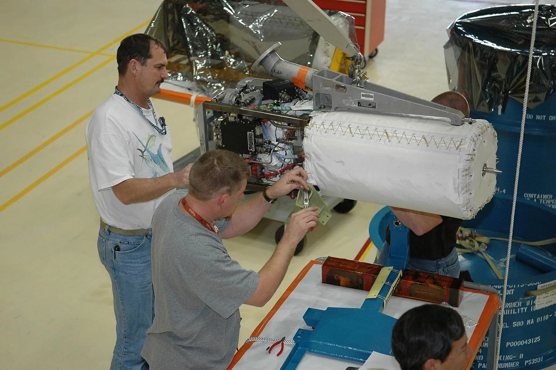 Engineers working on a fuel cell module in a workshop