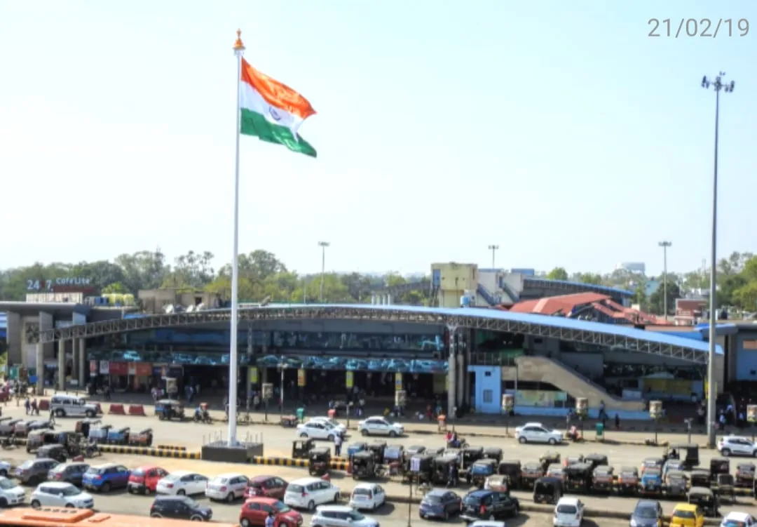 A cricket stadium with the Indian flag flying above it