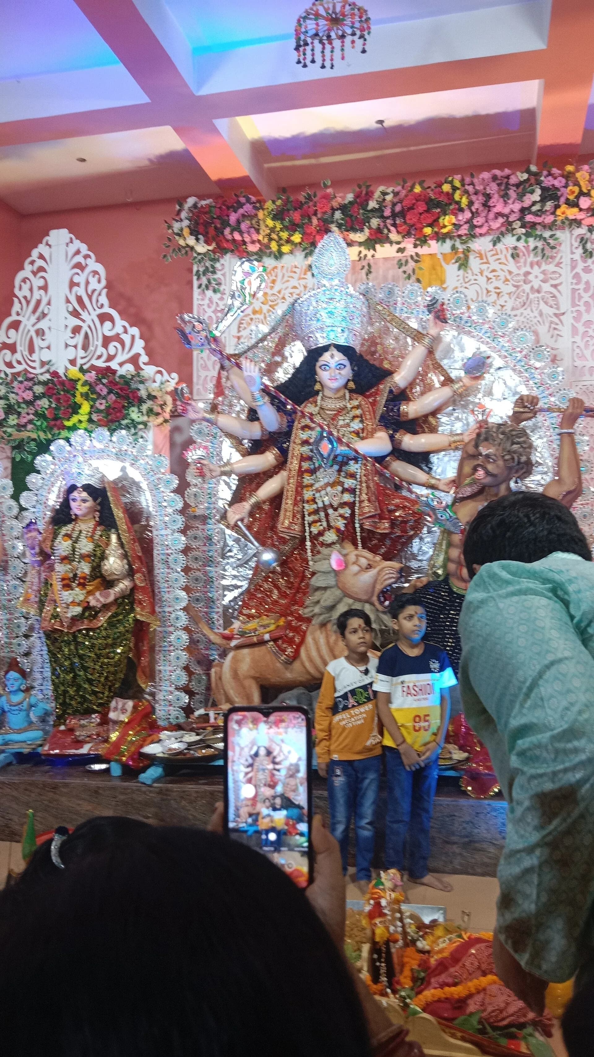 A decorated Durga Puja idol inside a pandal