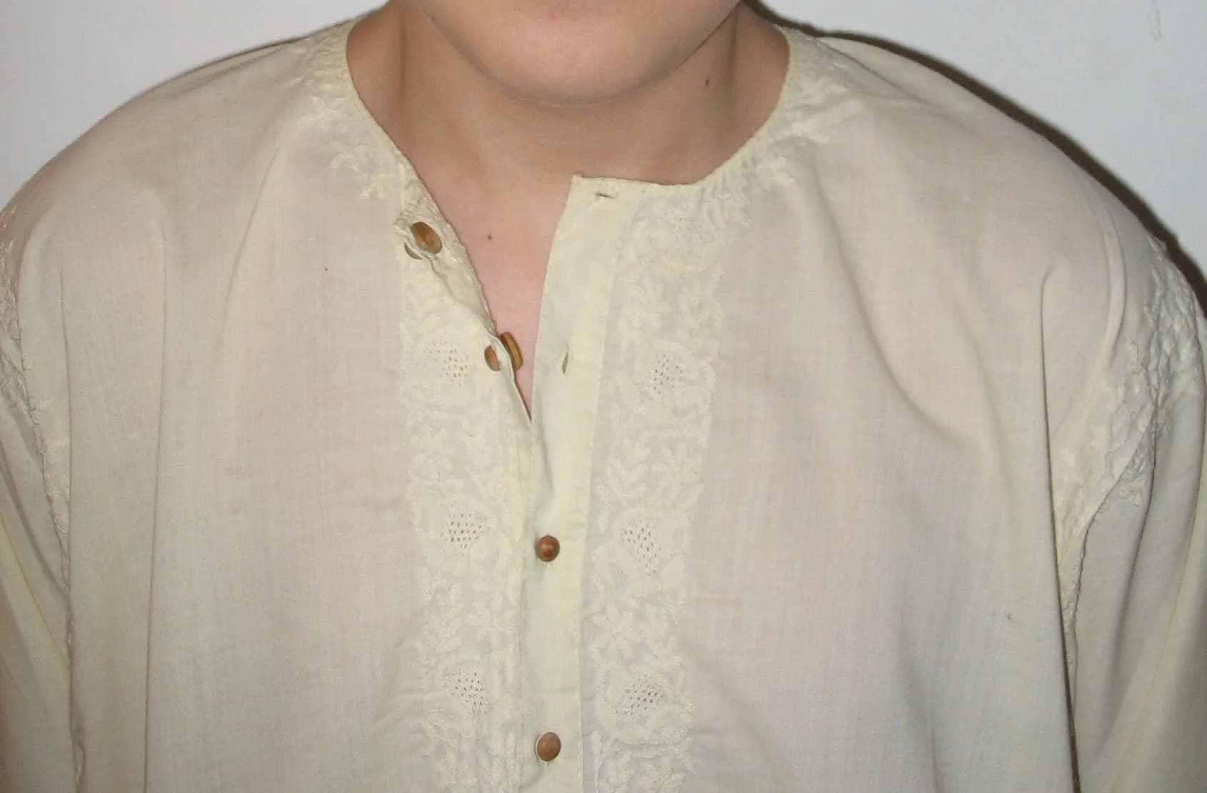 Close-up of a cream kurta with wooden buttons