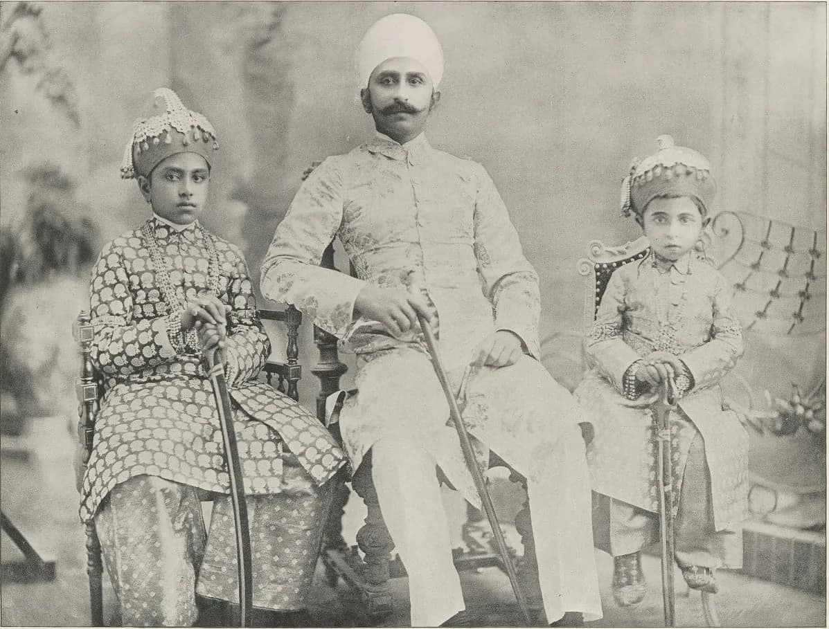 An old photograph of men in formal Indian court dress