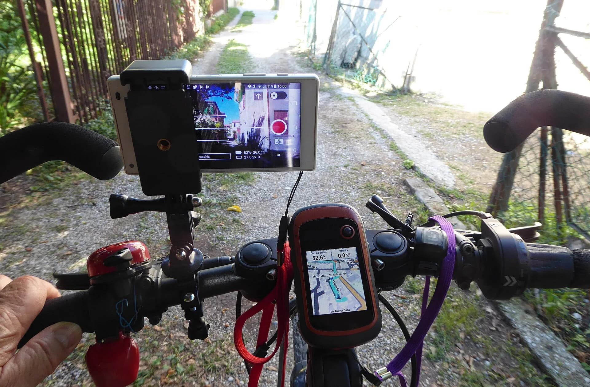 A phone showing a map, mounted on bicycle handlebars