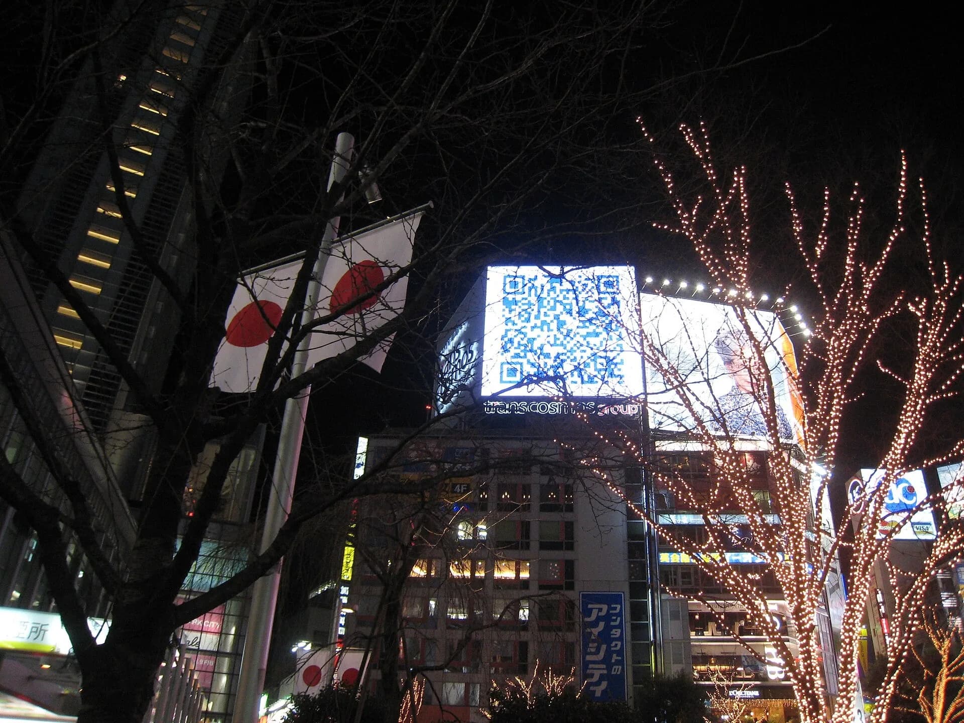 A huge QR code on a billboard in a city street