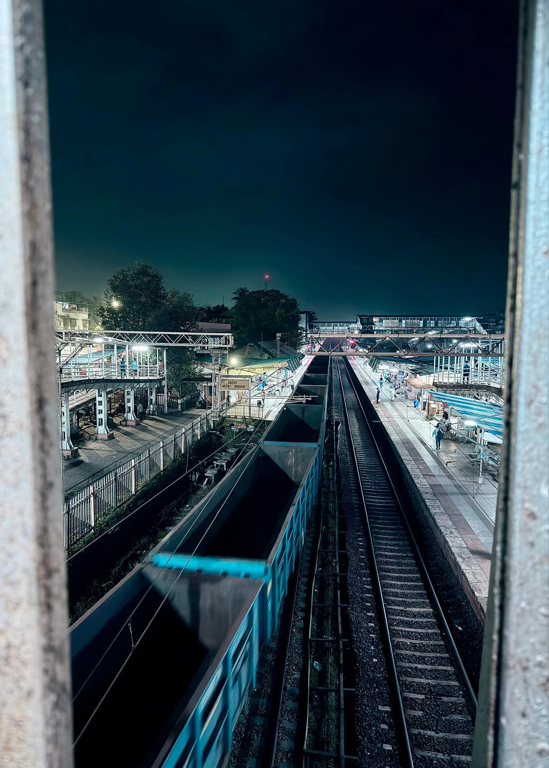 Railway tracks and freight wagons in a yard at night