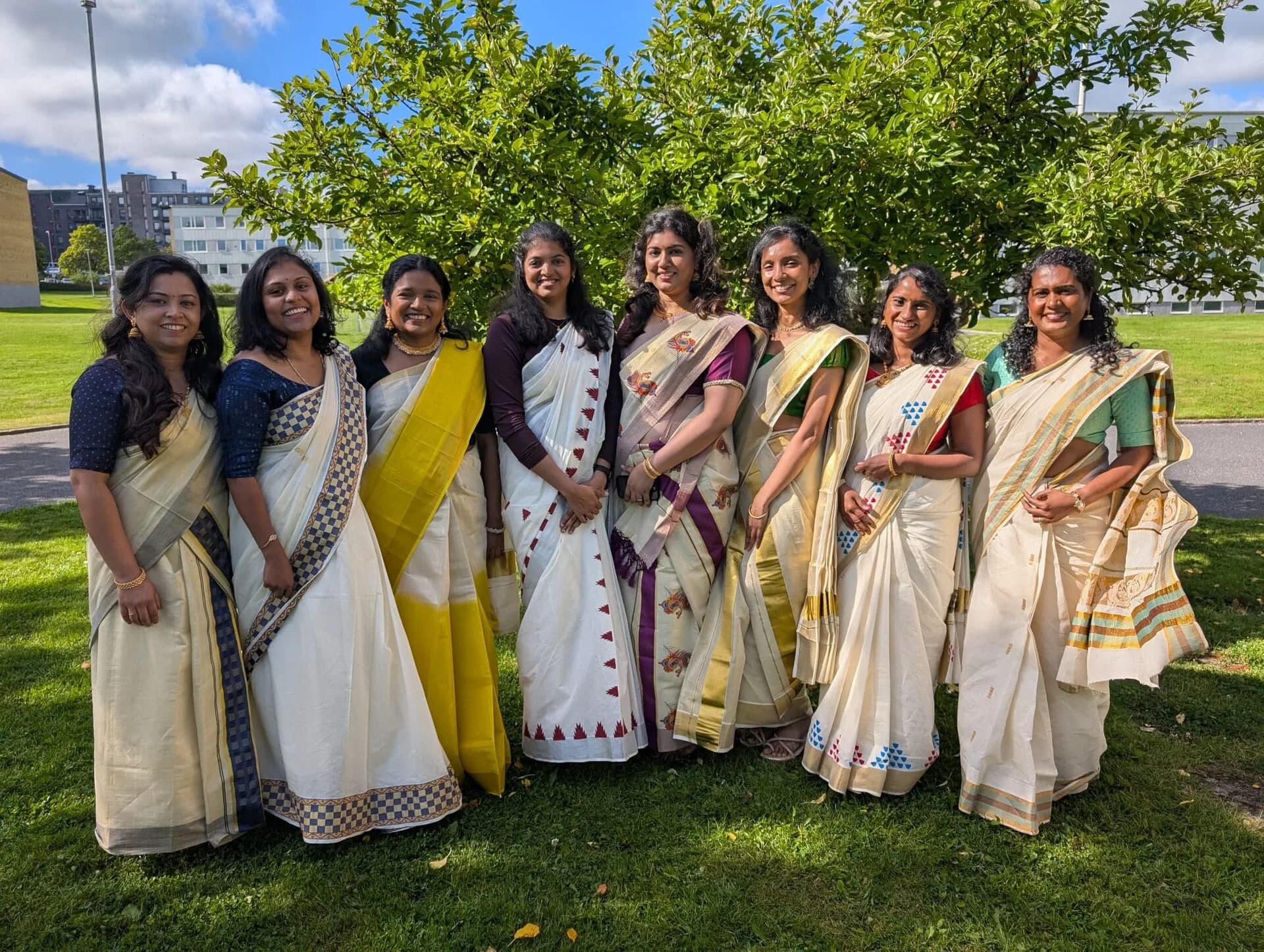 Women in Kerala sarees preparing to dance for Onam